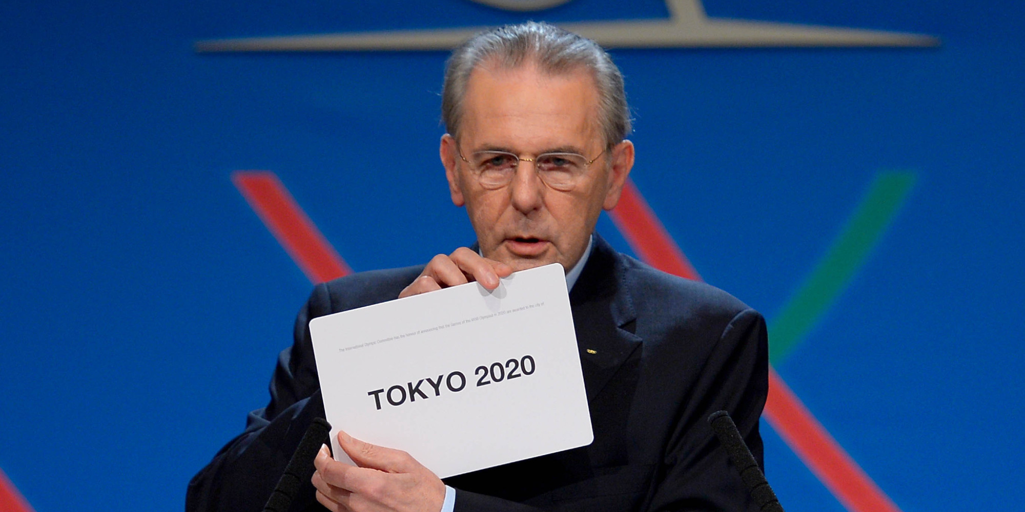 International Olympic Committee (IOC) President Jacques Rogge shows the name of the city of Tokyo elected to host the 2020 Summer Olympics in Buenos Aires, Argentina, Saturday, Sept. 7, 2013.  (AP Photo/Fabrice Coffrini, Pool)